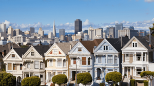 row of painted ladies houses with city in the background