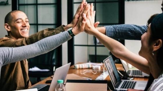coworkers high-fiving in the office