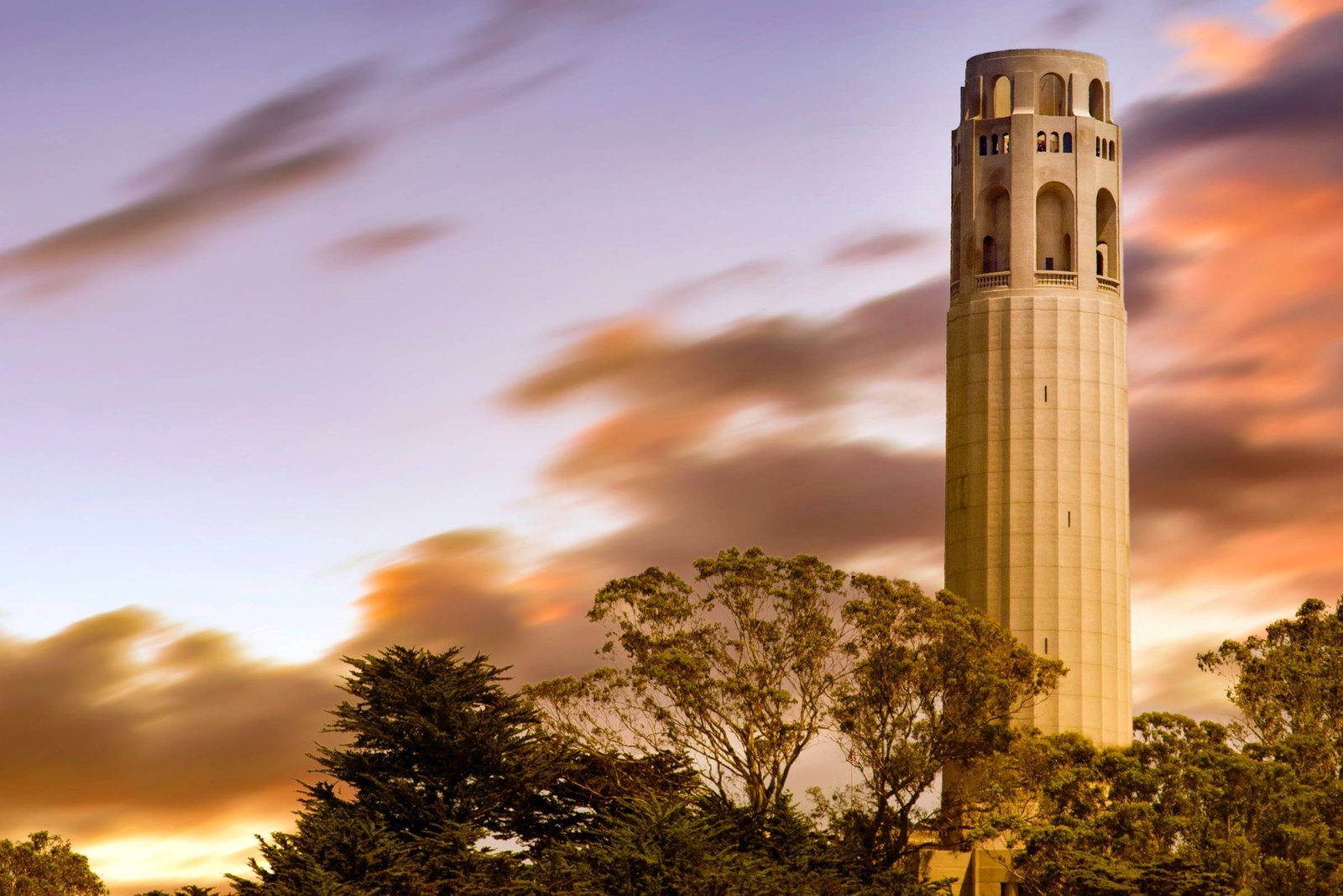 sunset behind closeup of coit tower