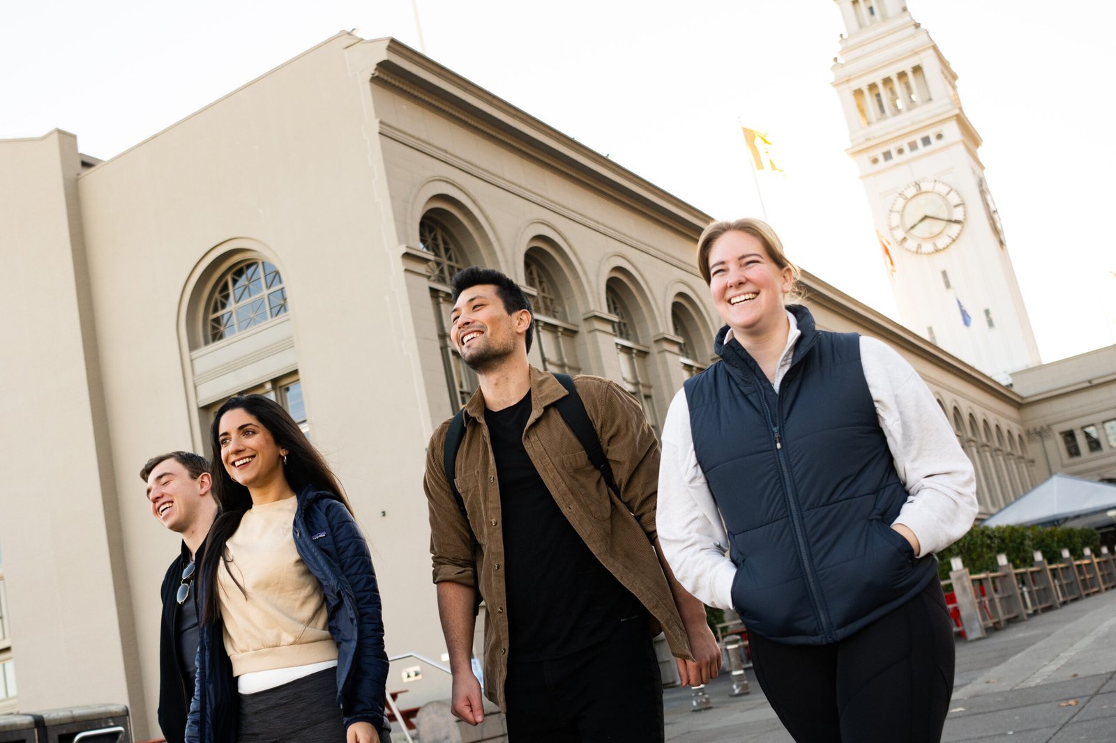 Friends smiling and walking together in San Francisco.