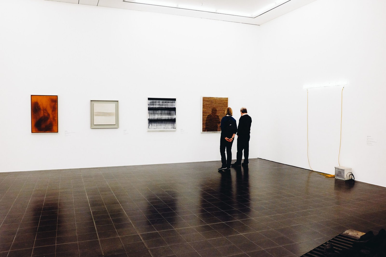 Couple observing art together in a gallery