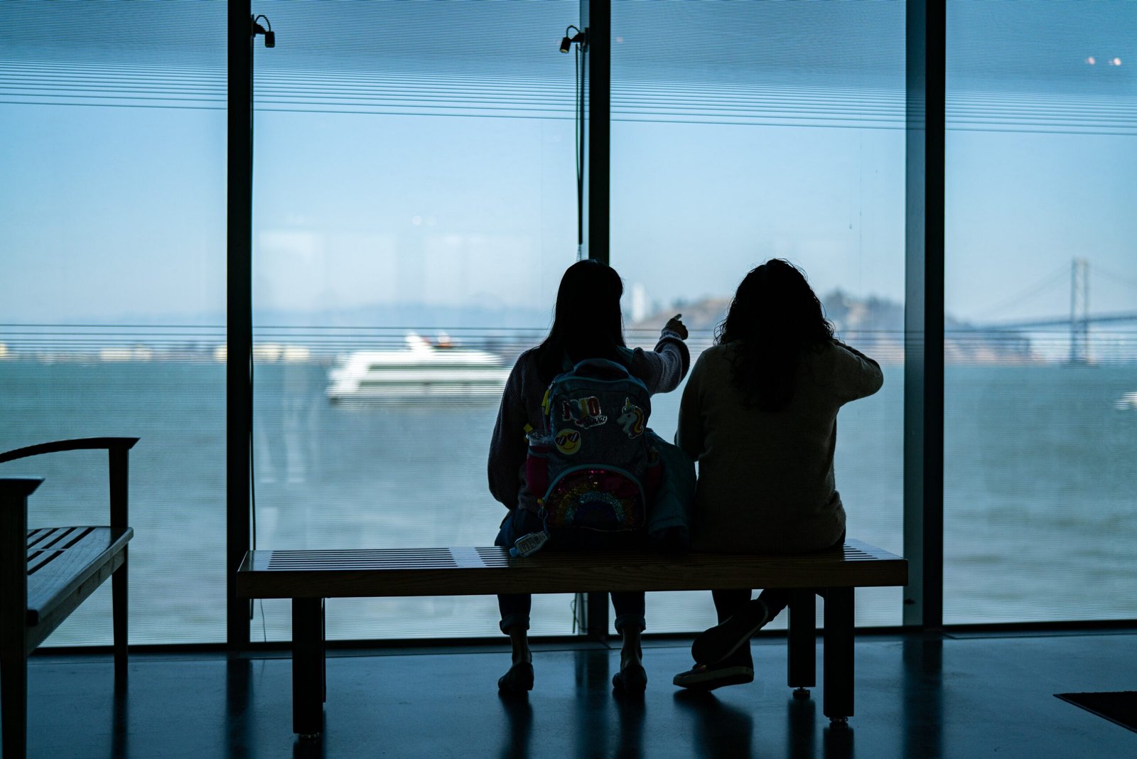 People staring out at the bay from the Exploratorium in San Francisco
