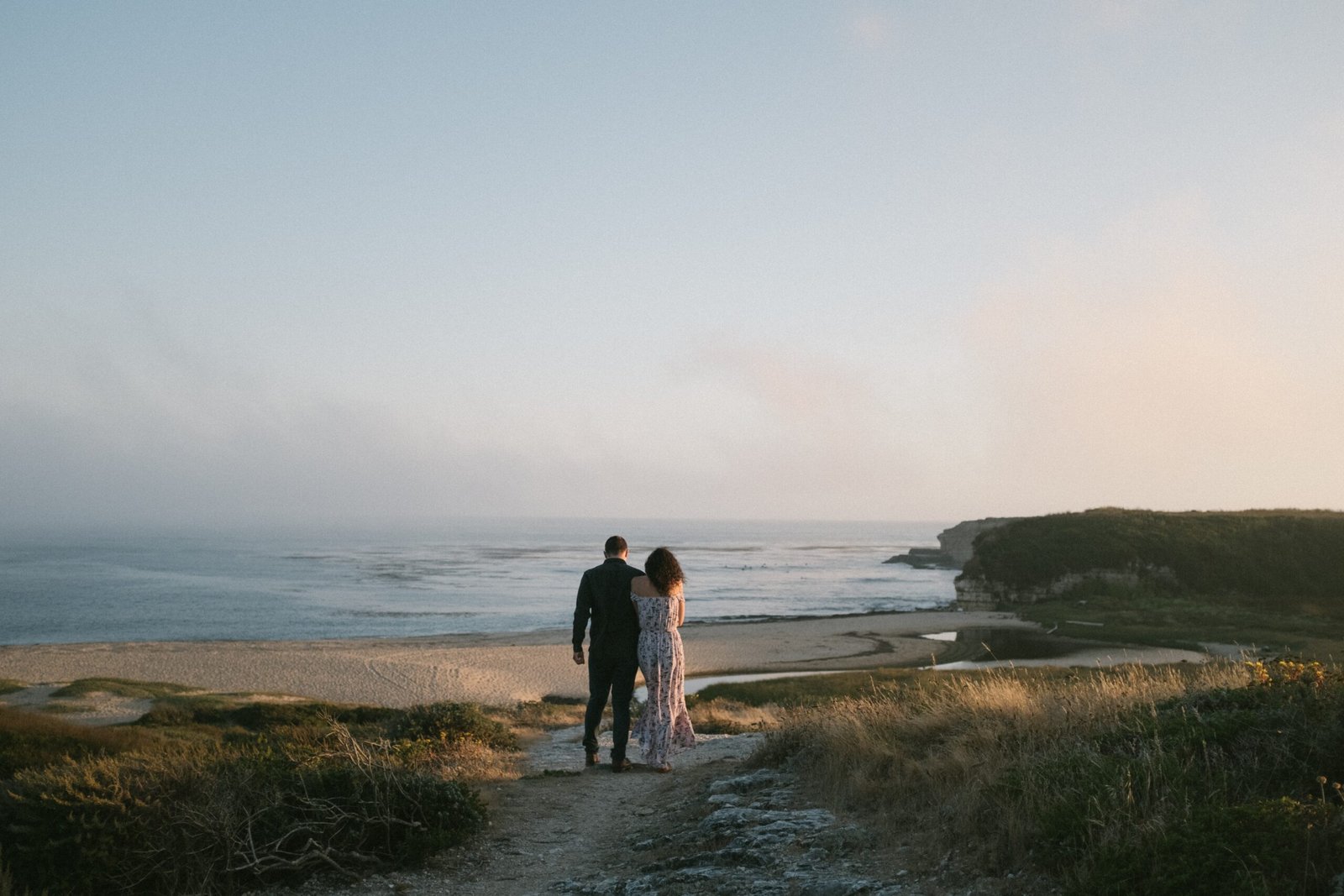 Couple walking on a beach in Santa Cruz