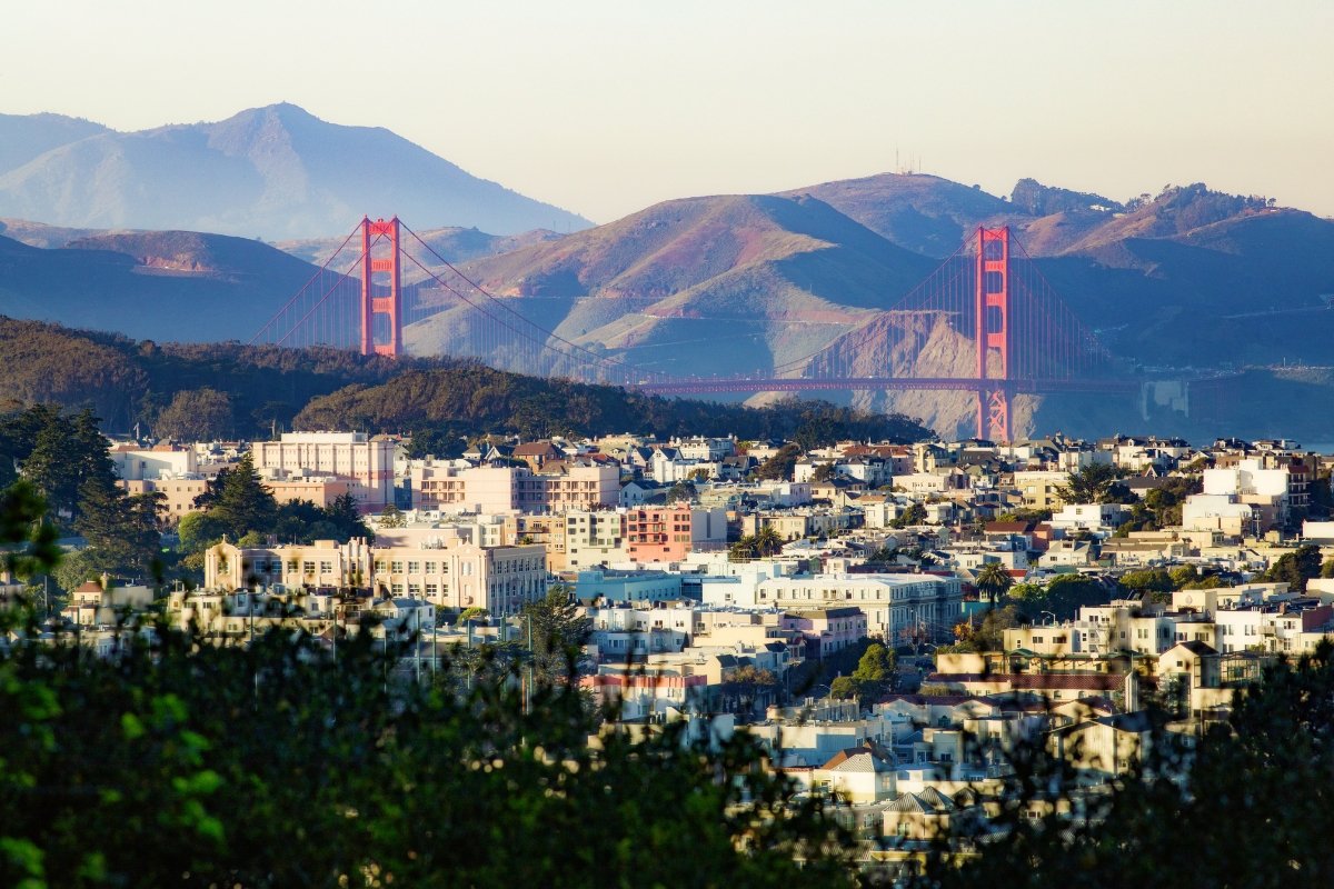 Panoramic view of the iconic Golden Gate Bridge framed by San Francisco houses with Marin Headlands in the background