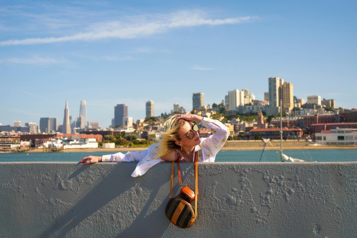 Person enjoying view of San Francisco skyline with Transamerica Pyramid and Salesforce Tower from waterfront