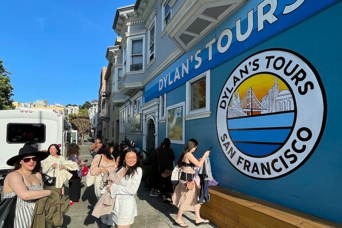 Tourists Gathering Outside Dylan's Tours Blue Victorian Building in San Francisco
