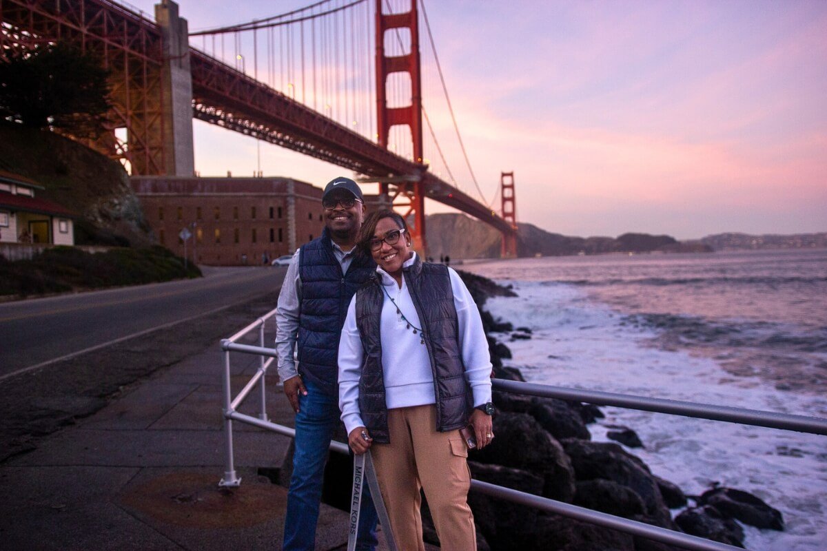 Couple Enjoying Sunset View of Golden Gate Bridge in San Francisco
