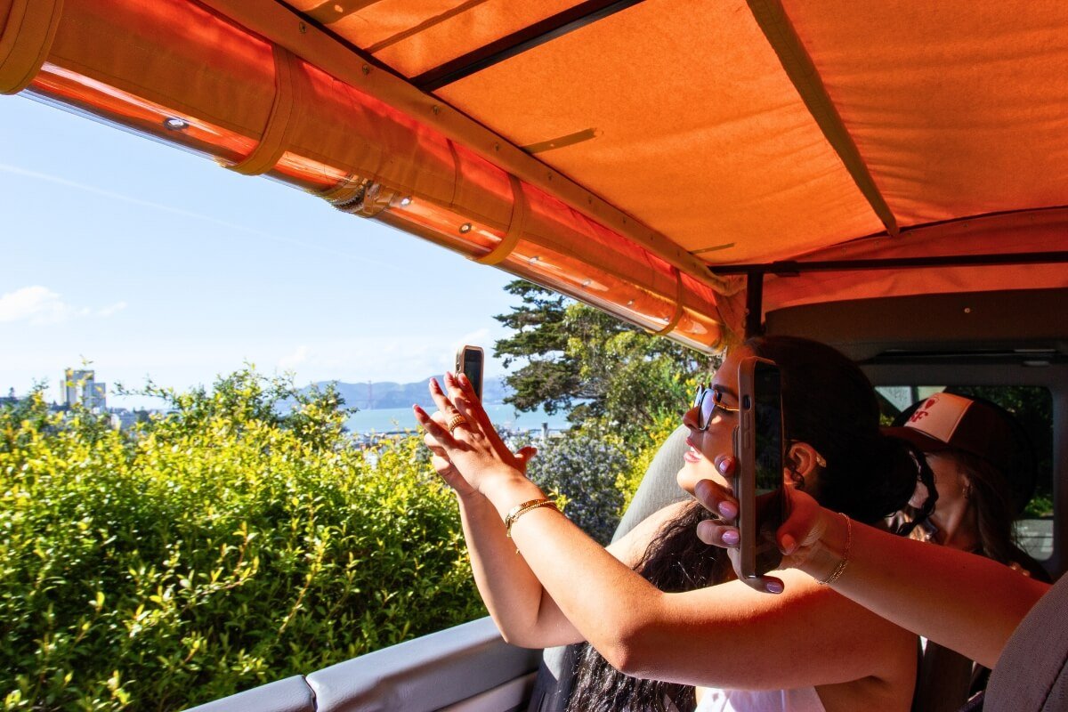 Tourists Taking Photos from Open-Air Tour Bus of San Francisco Bay
