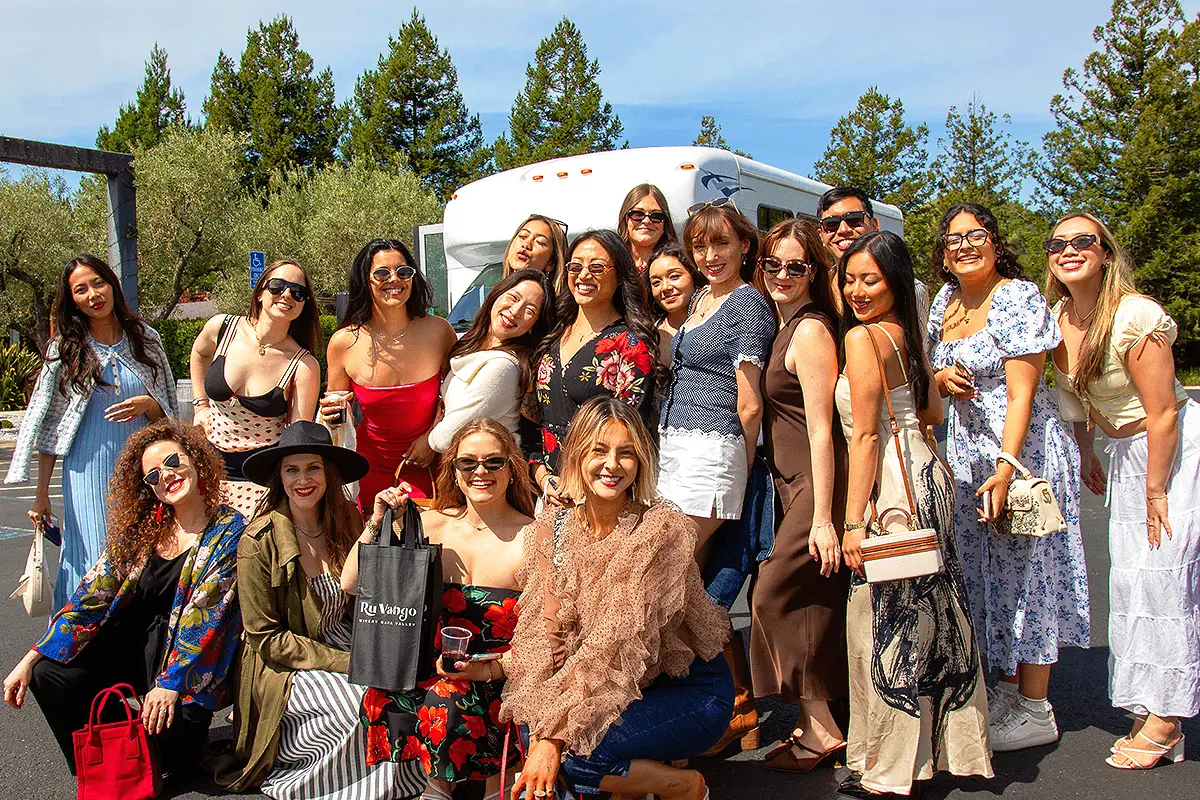 A group of women enjoying a Napa Valley tour with Dylan's Tours, smiling in a vineyard setting.