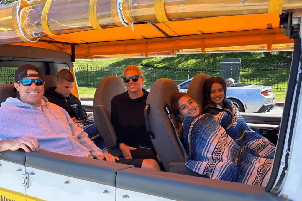 Smiling family riding inside Dylan’s private tour van during a San Francisco excursion