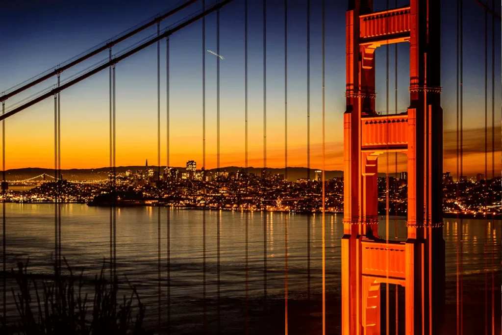 Evening cityscape of San Francisco just after sunset with the Golden Gate Bridge overlaying the skyline