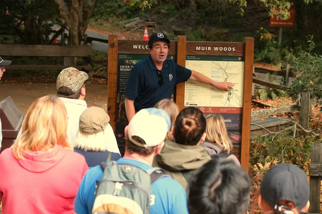 Dylan’s Tours guide explaining the redwood forest to a group of tourists at Muir Woods