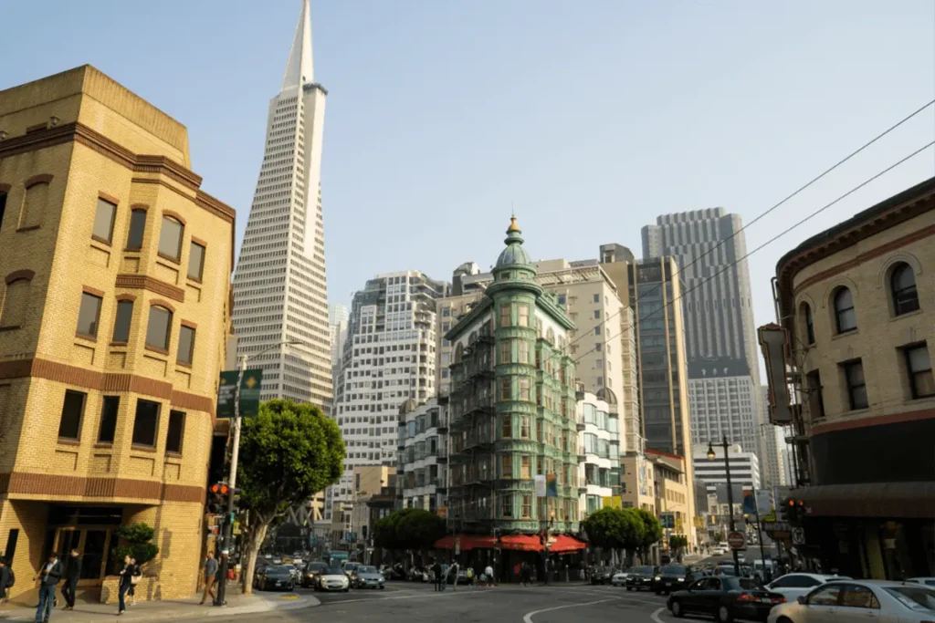 Street view of North Beach in San Francisco with colorful buildings, cafes, and pedestrians