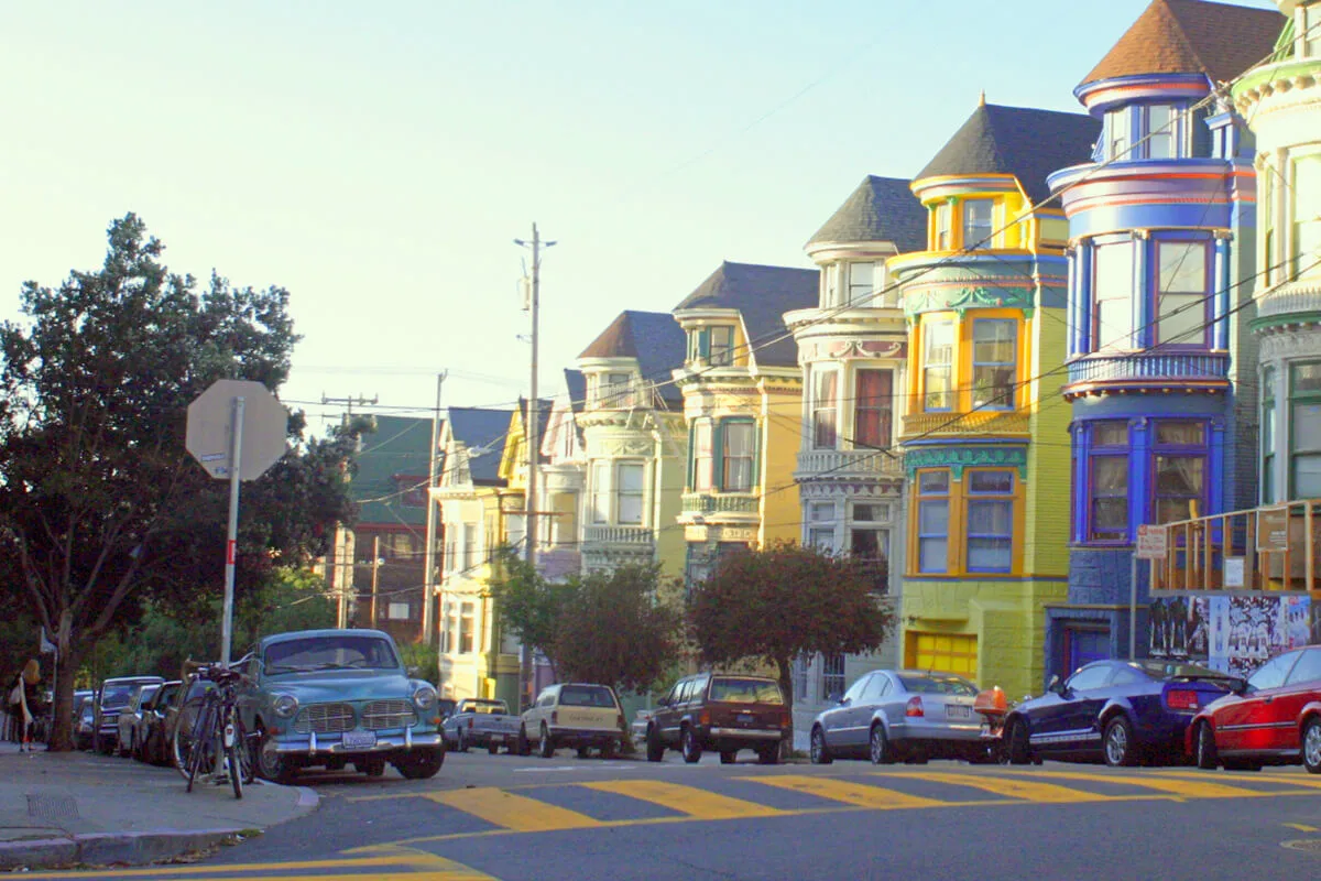 Colorful Victorian houses lining a street in San Francisco’s Haight-Ashbury neighborhood.