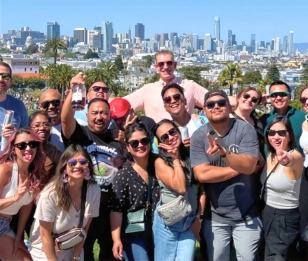 Happy tourists on San Francisco tour with city skyline background