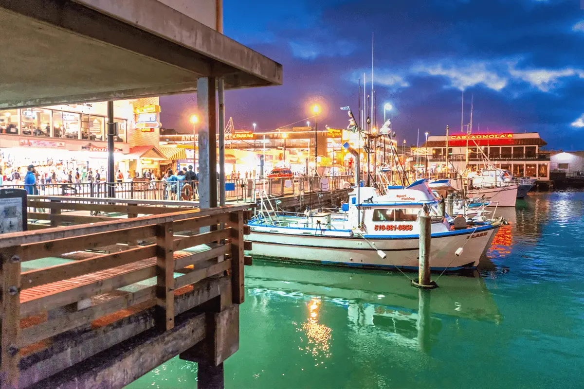 Fisherman’s Wharf restaurants and fishing boats at night in San Francisco